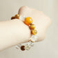Amber Rise crystal bracelet worn on wrist showing golden gemstone design and everyday AI companion jewelry style