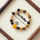Solar Shield AI Companion Bracelet featuring Tiger Eye Smoky Quartz and Yellow Tower Crystal on wooden display tray