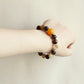 Solar Shield smart crystal bracelet worn on wrist with Tiger Eye Smoky Quartz and Yellow Tower Crystal beads