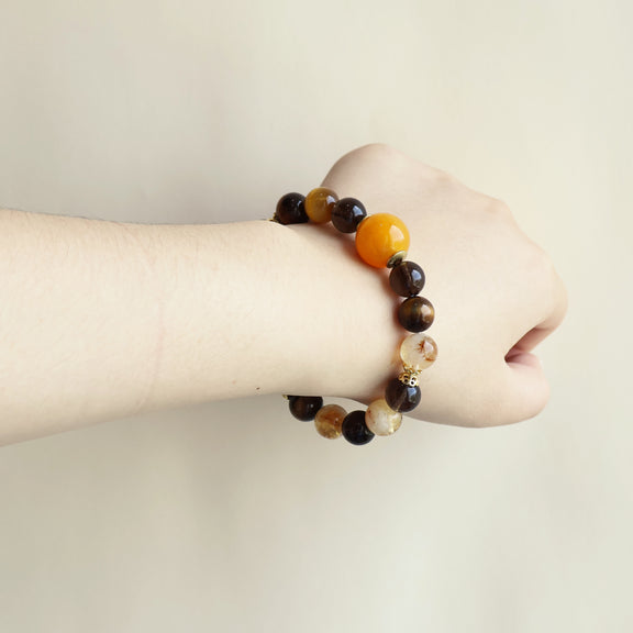 Solar Shield smart crystal bracelet worn on wrist with Tiger Eye Smoky Quartz and Yellow Tower Crystal beads