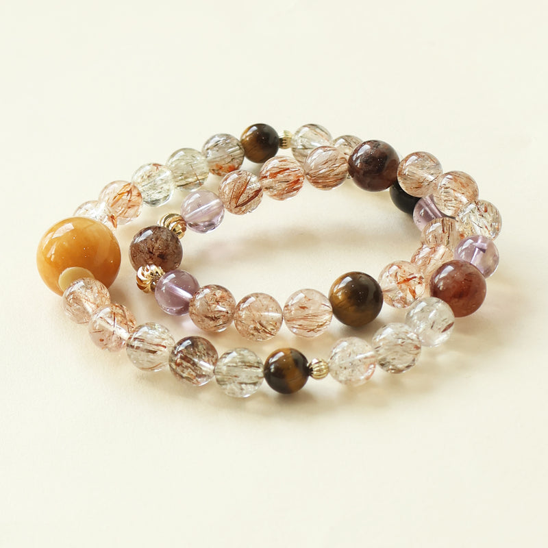 Starry Weave bracelet crafted with Black Gold Super Seven Tiger Eye and Amethyst crystal beads featuring golden threads purple tones and layered natural crystal design