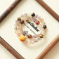 ZENSTELLAR Starry Weave AI Companion Bracelet with Black Gold Super Seven Tiger Eye and Amethyst crystals in elegant jewelry presentation