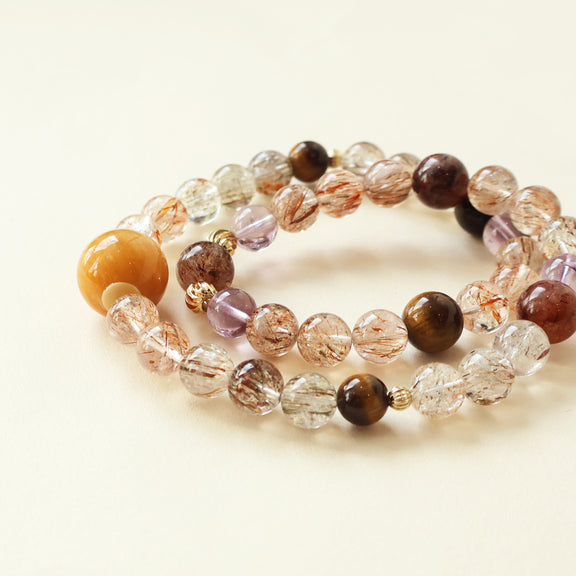 Close up of Starry Weave AI Companion Bracelet showing Black Gold Super Seven inclusions Tiger Eye patterns Amethyst details and natural crystal bead texture