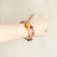 Starry Weave Black Gold Super Seven Tiger Eye Amethyst bracelet worn on wrist showing luxury crystal style and everyday jewelry look
