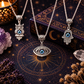 Three evil eye symbol necklaces with Hamsa, owl and mystical pendants