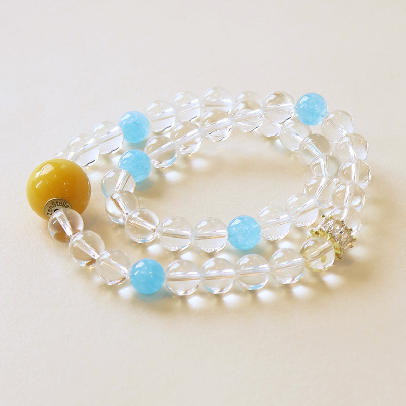 Aqua Veil crystal bracelet featuring clear quartz beads and blue chalcedony accents on a soft minimalist background