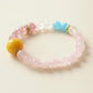 Rose Dream crystal bracelet with soft pink Rose Quartz beads, Strawberry Quartz, Snowflake Phantom, Blue Chalcedony accents and warm golden details