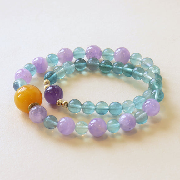 Crystal Veil bracelet crafted with Amethyst and Fluorite crystal beads featuring soft purple tones, blue green gradients and translucent crystal design