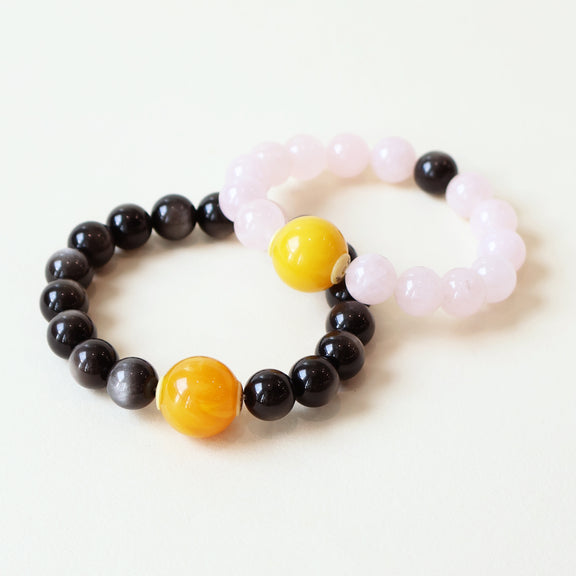 Shadow Bloom crystal couple bracelets crafted with natural Silver Obsidian and Rose Quartz beads with NFC smart companion beads