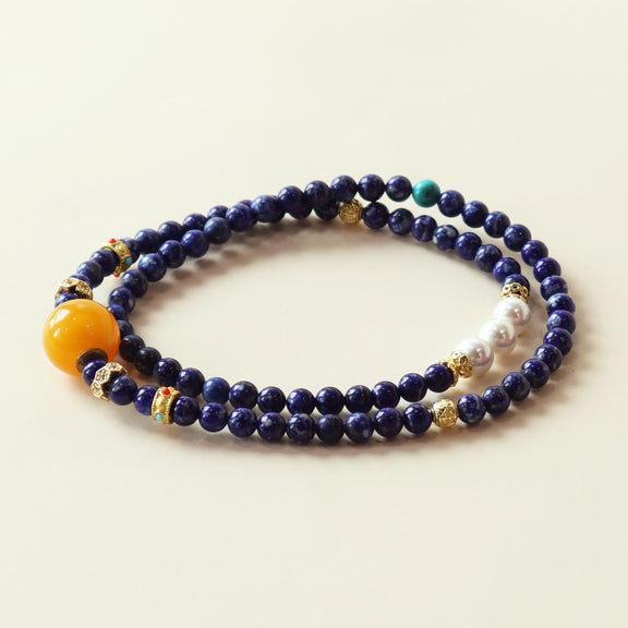 Star Dream lapis lazuli bracelet featuring deep blue crystal beads, beeswax accent and elegant layered design