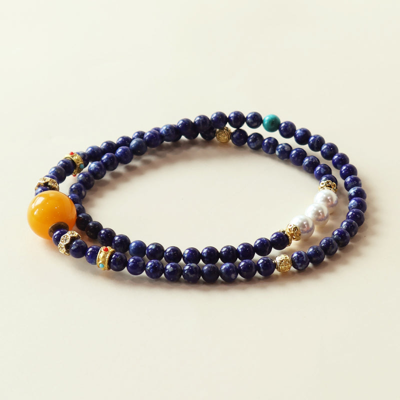 Star Dream lapis lazuli bracelet featuring deep blue crystal beads, beeswax accent and elegant layered design