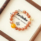 SUNSET AURA AI Companion Bracelet Displayed on Elegant Jewelry Tray with Warm Natural Light