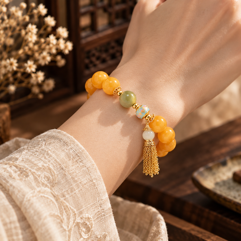 Amber and jade tassel bracelet worn on wrist