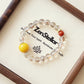 Lucent Aura AI bracelet displayed on elegant tray with polished crystal beads and premium jewelry presentation