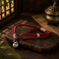 Adjustable Persimmon Wish red braided cord bracelet with silver-plated copper charm