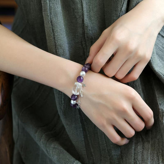 Amethyst and clear quartz celestial bracelet worn on wrist