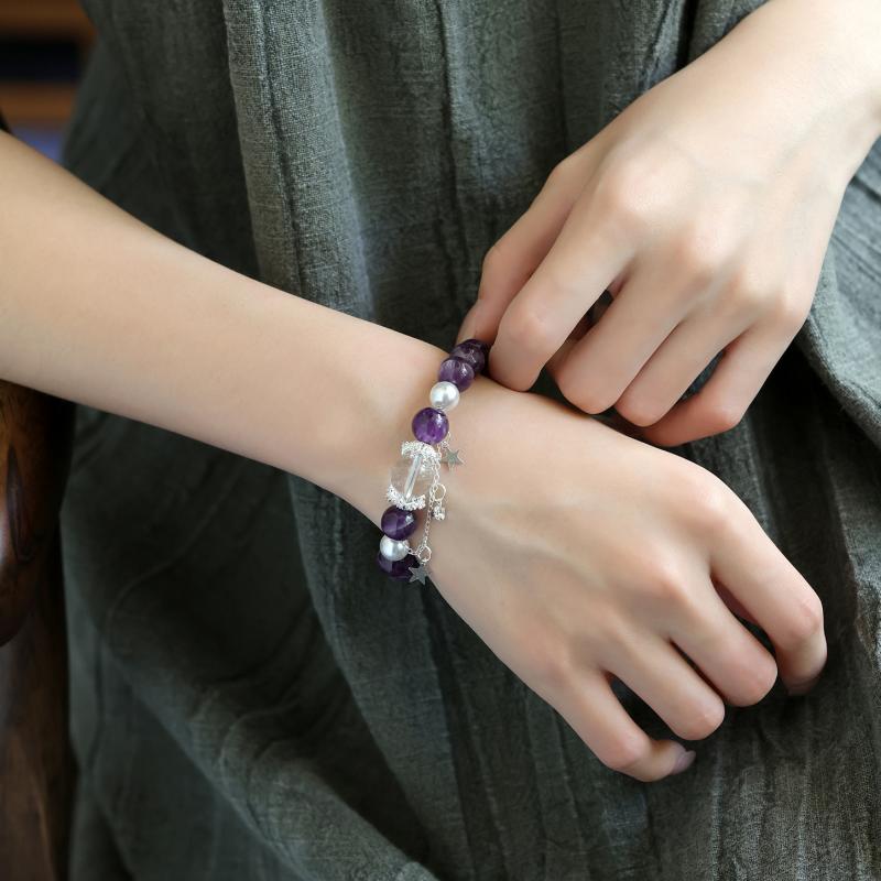 Amethyst and clear quartz celestial bracelet worn on wrist