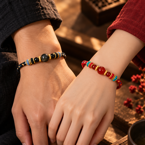 Matching Red Agate and Black Obsidian couple bracelets worn on wrists