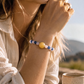 Libra crystal bracelet worn on wrist featuring Rose Quartz and Kyanite gemstones