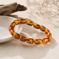 Amber bead bracelet showing polished freeform shapes and natural color variations