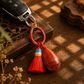 Natural crystal tassel keychain attached to car keys with colorful handwoven cord and tassel
