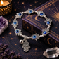 Hamsa hand evil eye bracelet with blue resin details and silver-tone charms