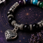 Ornate heart charm and silver-tone details on mixed crystal bracelet