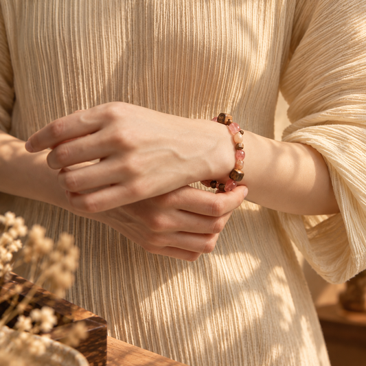 Strawberry Quartz, Sunstone and Agarwood bracelet worn on wrist