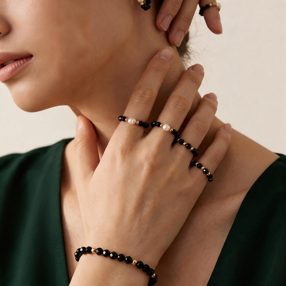 Three black spinel beaded rings styled together with pearl accents