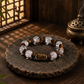 Clear quartz and agarwood bracelet displayed on a dark textured stone surface