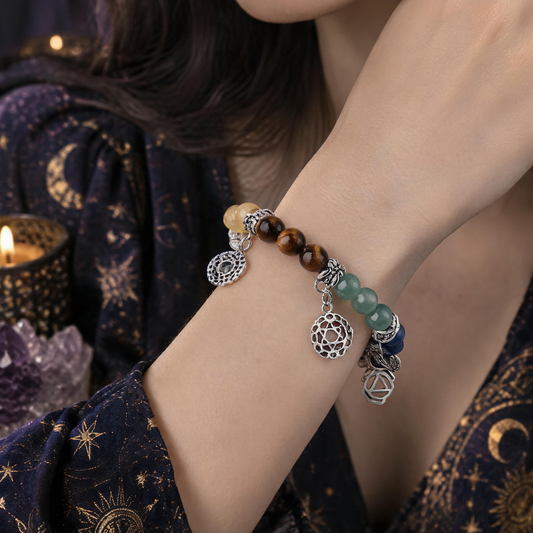 7 chakra natural gemstone bracelet with silver charms worn on wrist