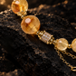 Yellow Azeztulite bracelet with zircon spacers and gold-plated copper details