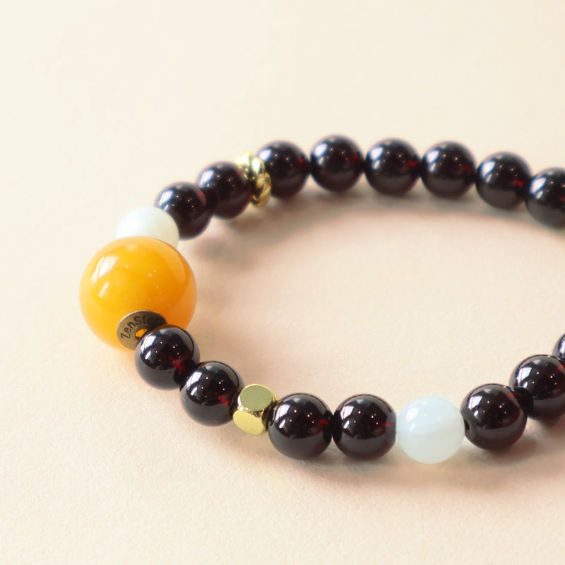 Ember Moon crystal bracelet close up showing Garnet Moonstone beads and premium handcrafted jewelry details