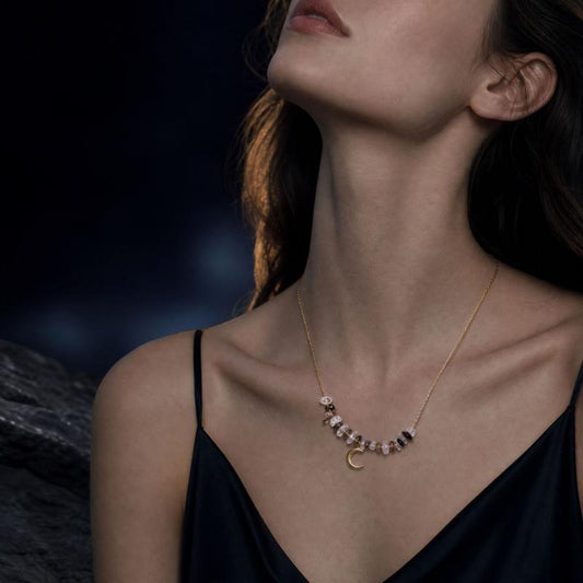 Ice obsidian and clear quartz crescent moon necklace worn on neck