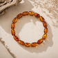 Freeform amber bracelet with polished translucent beads in warm golden tones