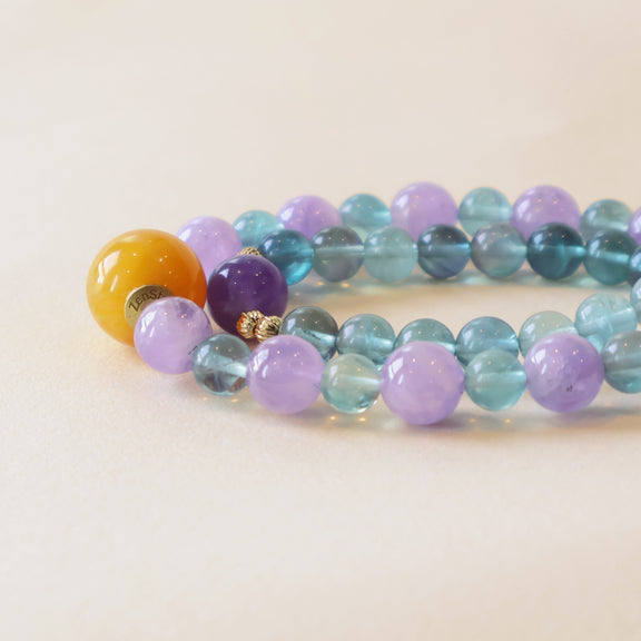 Close up of Crystal Veil bracelet showing Amethyst purple beads, Fluorite blue green tones and polished crystal details