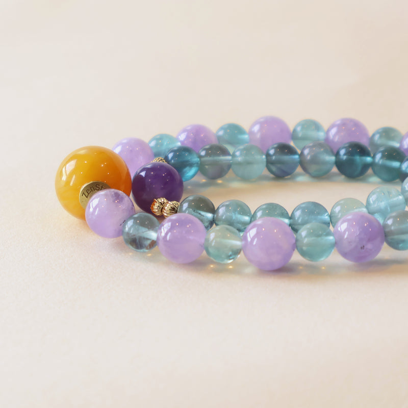 Close up of Crystal Veil bracelet showing Amethyst purple beads, Fluorite blue green tones and polished crystal details