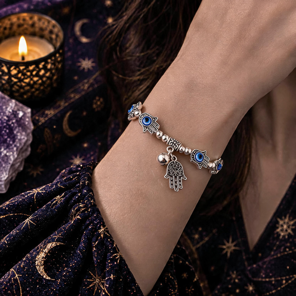 Hamsa hand evil eye bracelet worn on wrist with dangling charm
