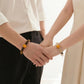Couple wearing matching bracelets representing love connection and shared moments