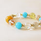 Azure Dawn AI Companion Bracelet worn on wrist featuring Amazonite Citrine Clear Quartz and Golden Rutilated Quartz crystal beads with elegant everyday styling