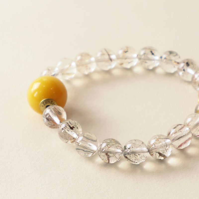 Close up of Lucent Aura bracelet featuring Black Gold Super Seven crystal texture, Red Agate detail and polished bead finish