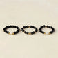 Black spinel and freshwater pearl rings shown in three coordinating designs