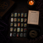 Bloodstone rune stones set for divination with engraved gold symbols and rune pouch