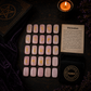 Rose Quartz rune stones set for divination with engraved gold symbols and rune pouch