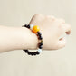 Ember Moon Garnet Moonstone AI smart crystal bracelet worn on wrist with modern everyday jewelry style