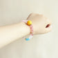 Rose Dream crystal bracelet worn on wrist showing soft pink gemstone design and everyday AI companion jewelry style