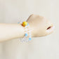 Aqua Veil bracelet worn on wrist showing elegant clear quartz and blue crystal bead design