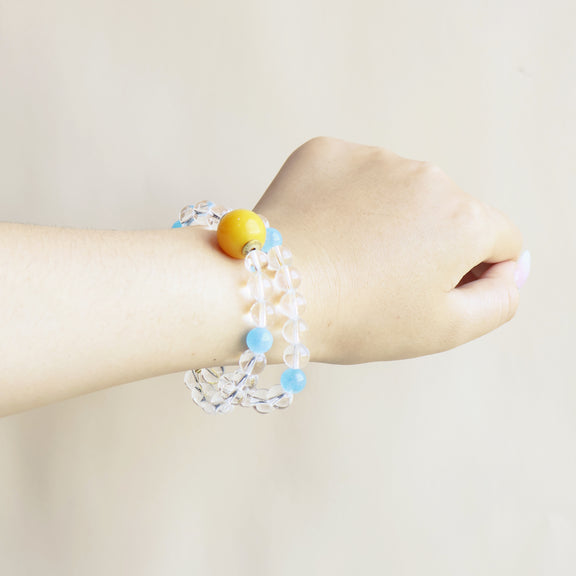 Aqua Veil bracelet worn on wrist showing elegant clear quartz and blue crystal bead design