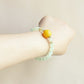 Jade Mist crystal bracelet worn on wrist featuring Prehnite, Golden Rutilated Quartz and NFC smart bead