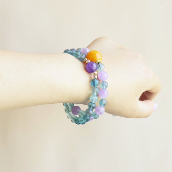 Crystal Veil Amethyst Fluorite bracelet worn on wrist showing colorful crystal style and everyday jewelry look